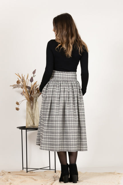 Back view of Wool Midi Plaid Skirt with High Waisted Bow and Pockets,
highlighting the midi length