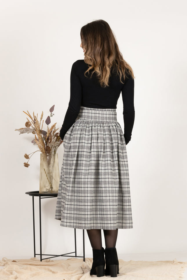 Back view of Wool Midi Plaid Skirt with High Waisted Bow and Pockets,
highlighting the midi length