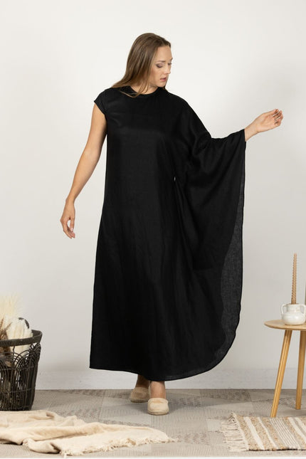 Model showcasing the front of the Extravagant Linen Dress with Batwing sleeves, emphasizing the dress's clean lines and minimalist elegance.