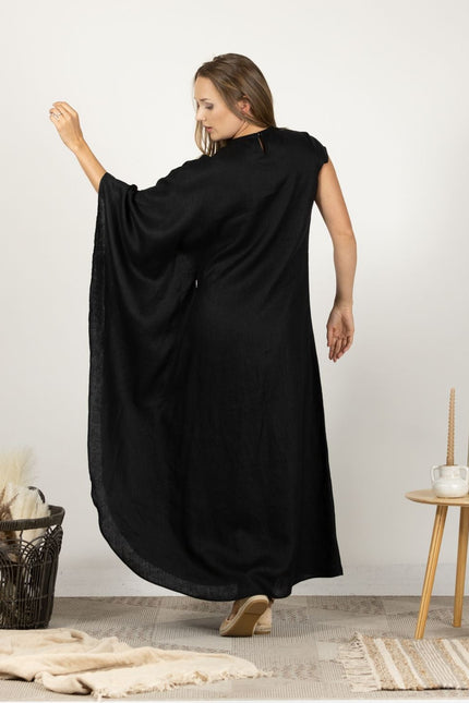 Back view of model in the Extravagant Linen Dress with Batwing sleeves, highlighting the dress's full length and elegant drape.