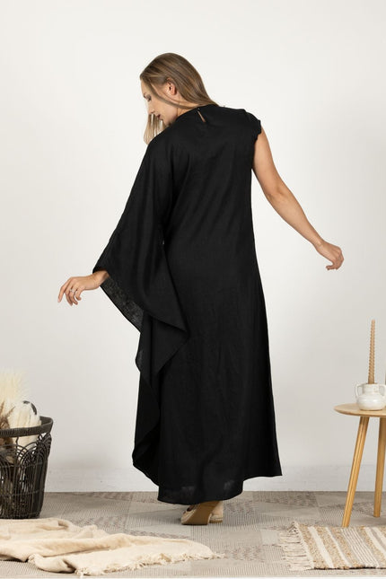 Model presenting the back of the Extravagant Linen Dress with Batwing sleeves, showing the dress's graceful flow and full length.
