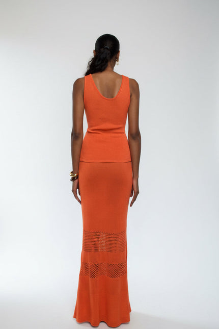 Woman wearing an orange dress with a white background