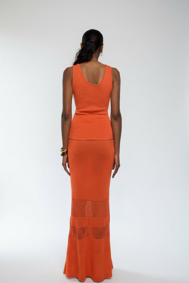 Woman wearing an orange dress with a white background