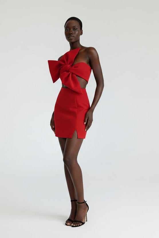 Red dress with a large bow detail on a white background