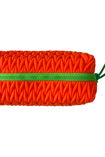 Squishy orange makeup bag by Lillyloves, soft wash bag with a playful, squeezable design for cosmetics storage.