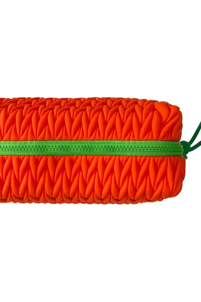 Squishy orange makeup bag by Lillyloves, soft wash bag with a playful, squeezable design for cosmetics storage.