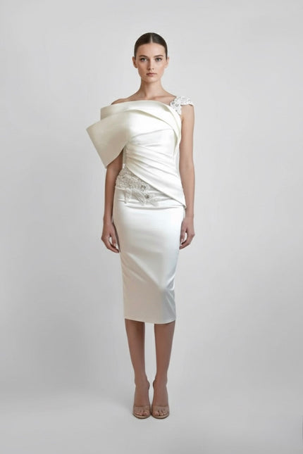 White one-shoulder dress with a draped design on a plain background