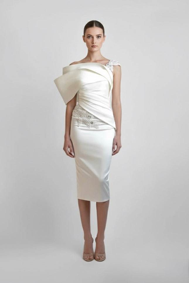 White one-shoulder dress with a draped design on a plain background