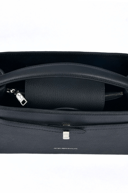 Black atelier galin cube lock handbag with silver hardware and brand logo top view