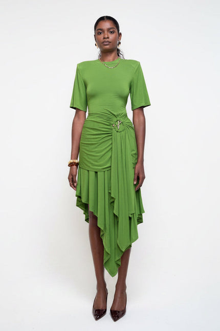 Woman wearing a green dress against a white background