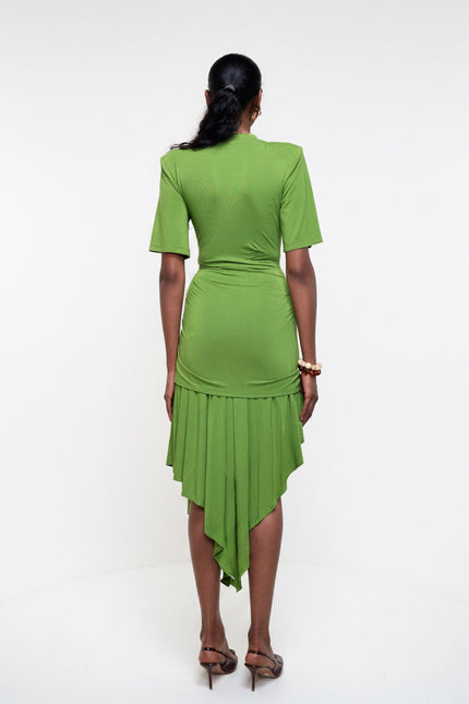 Person wearing a green dress against a white background