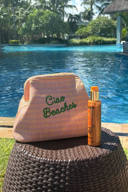 Lilly Loves Ciao Beaches pink clutch pouch with a stylish design, perfect for carrying essentials in a chic accessory.