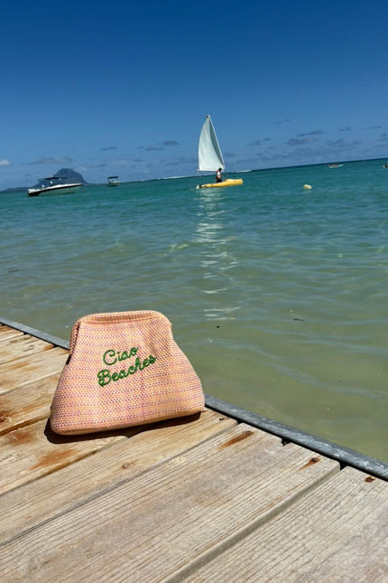 Lilly Loves Ciao Beaches pink clutch pouch with a stylish design, perfect for carrying small essentials in a chic fashion.