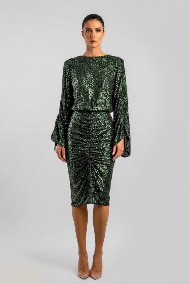 Woman wearing a green sequin dress on a white background