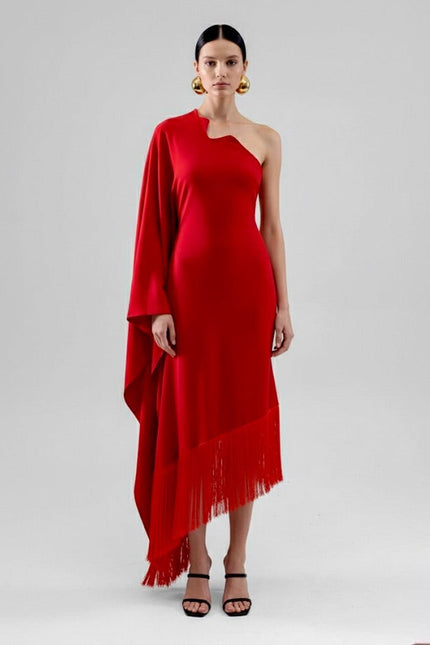 Woman wearing a red one-shoulder dress with fringe on a white background