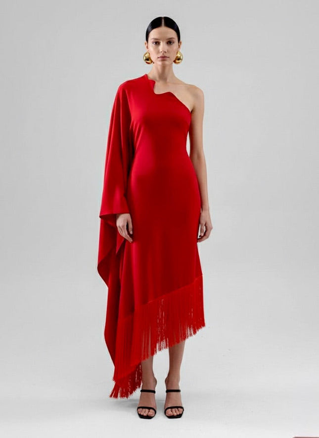 Woman wearing a red one-shoulder dress with fringe on a white background