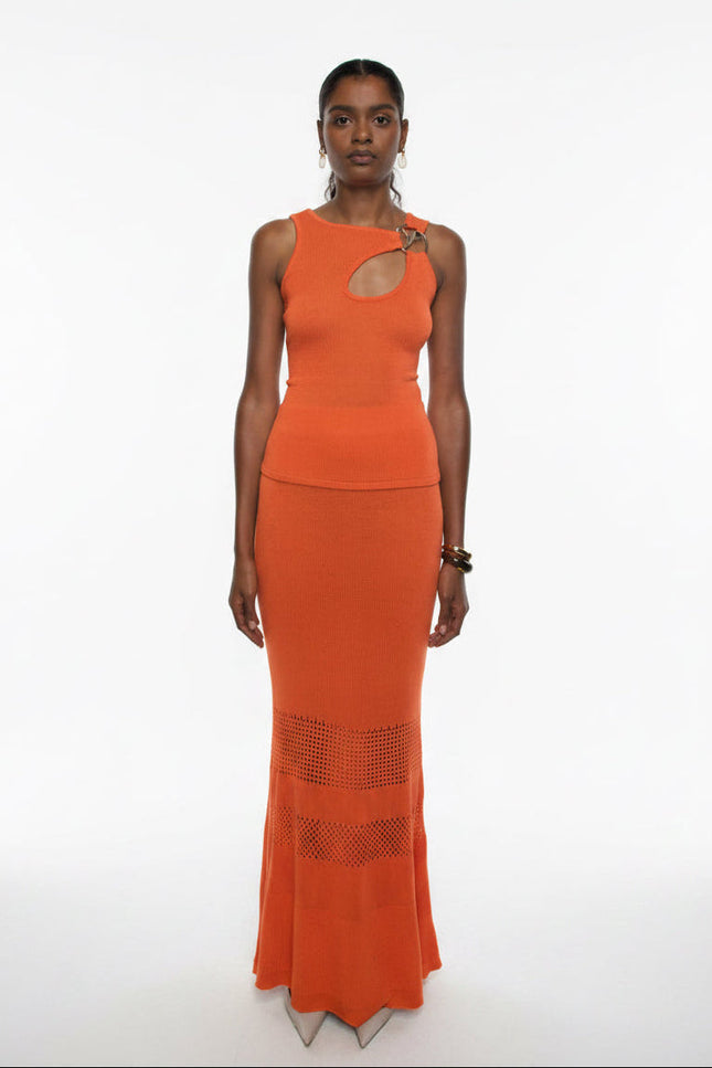 Woman wearing an orange dress with cut-out design on a white background