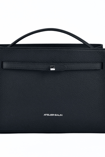 Black atelier galin cube lock handbag with silver hardware and brand logo on a white background