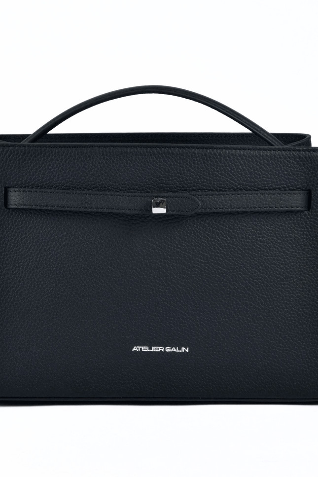 Black atelier galin cube lock handbag with silver hardware and brand logo on a white background