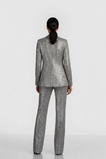 Person wearing a gray patterned suit on a white background