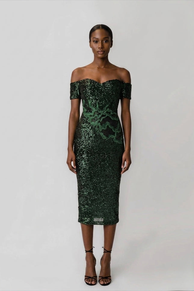 Woman wearing a green sequin off-shoulder dress on a white background
