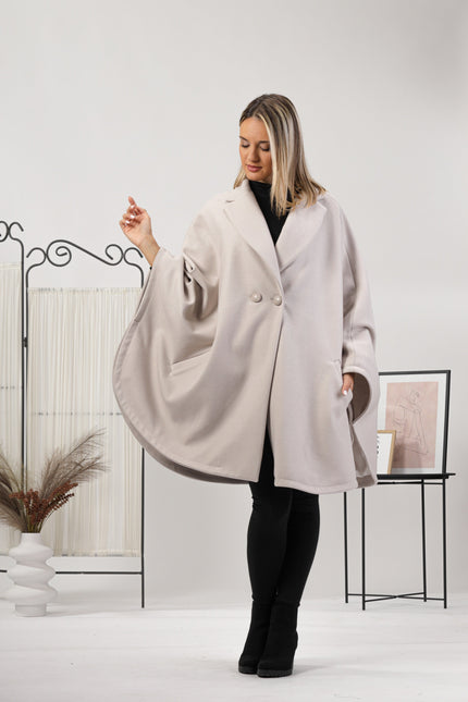 One-size off-white cape with relaxed drop shoulders