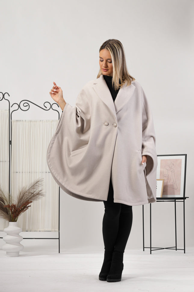 One-size off-white cape with relaxed drop shoulders