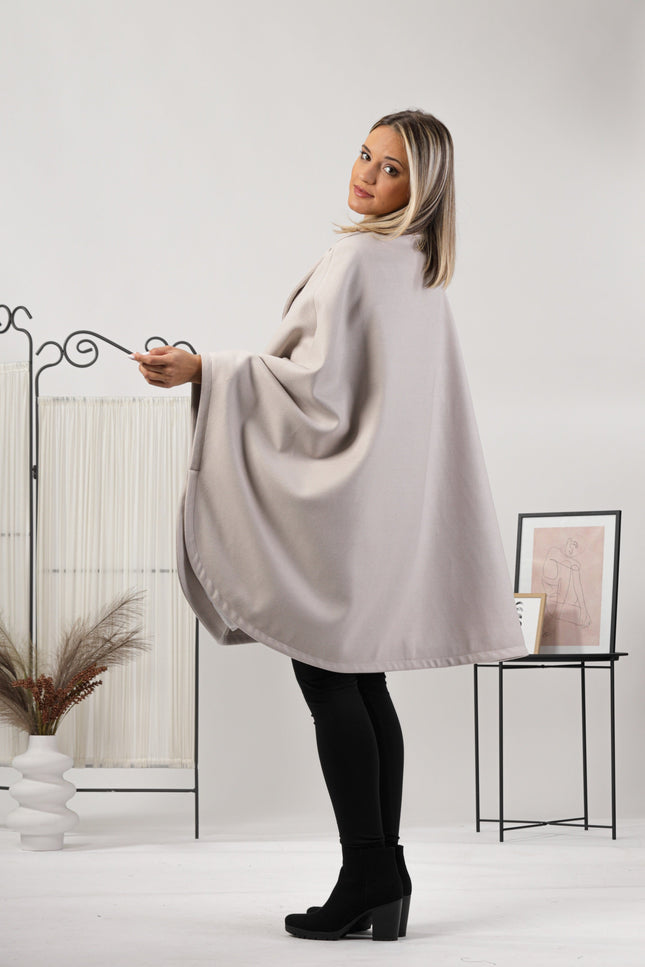 Back view of one-size off-white cape with relaxed drop shoulders