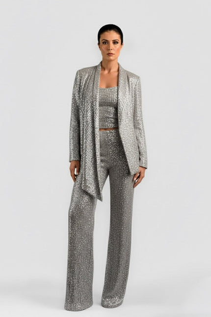 Woman wearing a silver sequin outfit on a white background
