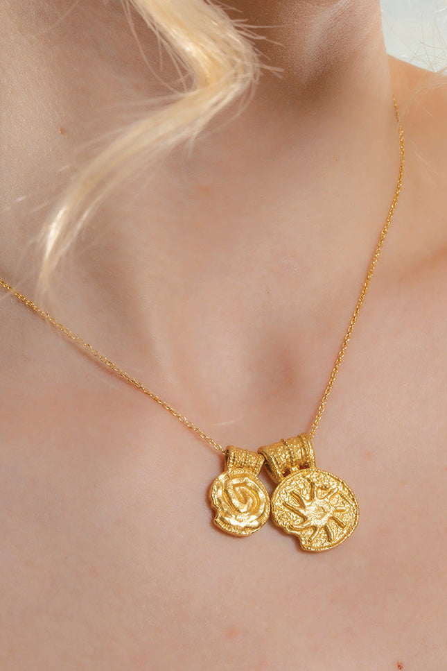 A gold-Plated  necklace with two pendant charms featuring ancient symbols.