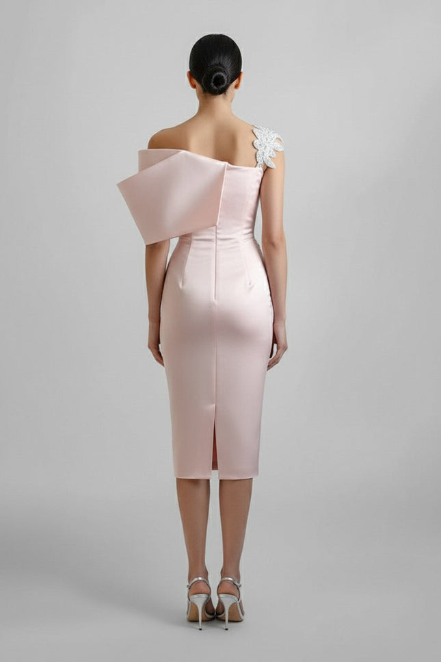Pink off-shoulder dress with a floral detail on a gray background