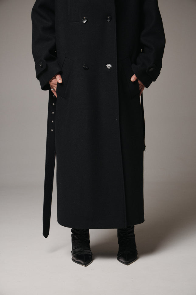 Black long coat with a belt on a gray background