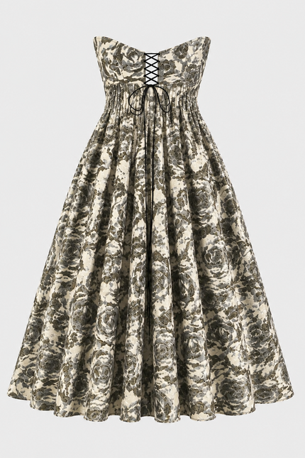 The Tala Corset Midi Dress by Sarvin is a strapless, ankle-length dress with a black and white floral pattern, featuring a fitted bodice with black lace-up front detail and a full gathered skirt for an elegant hourglass silhouette.