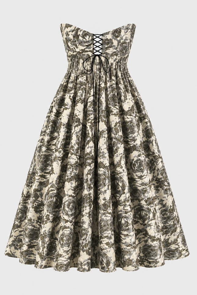 The Tala Corset Midi Dress by Sarvin is a strapless, ankle-length dress with a black and white floral pattern, featuring a fitted bodice with black lace-up front detail and a full gathered skirt for an elegant hourglass silhouette.