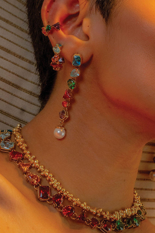 Close shot of model stacking Chromatic Cascade Ear Cuff  with other Ears jewelleries and nacklaces