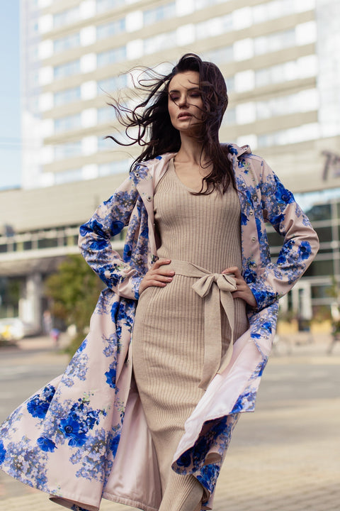 Model showcasing Cornflower Blue coat in motion – graceful A-line cut and pleated skirt flow