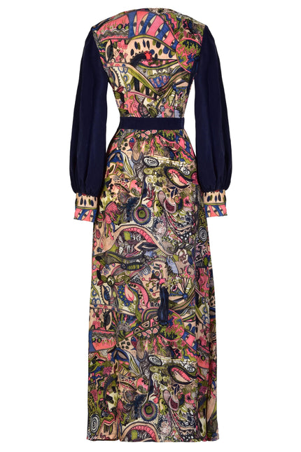 The Sarvin Hand Painted Long Sleeve Maxi Dress features a fitted waist, dark solid sleeves, and a colorful abstract pattern in pink, green, and yellow on the back and skirt for an eco-friendly evening look.