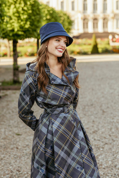 Model in Duchess in Blue coat with a chic hat for an elegant look.