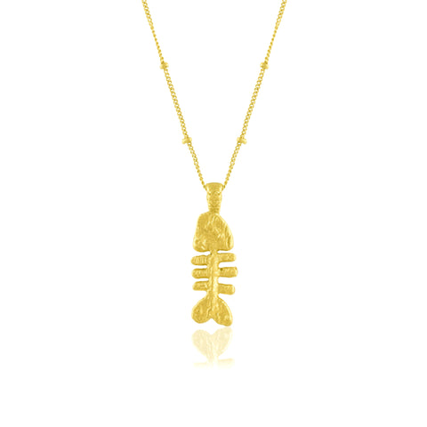 fish bone pendant necklace on a white background. Fish bone pendant  plated in real 22kt gold.