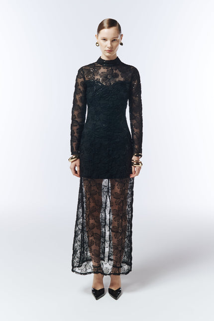 Model wearing SOUR FIGS 3D Floral Embroidered Mesh Evening Dress in Black with long sheer sleeves and tonal sequin details.