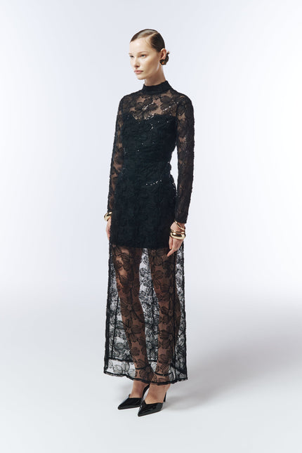 Side profile showcasing sheer embroidered overlay and sculpted column silhouette.