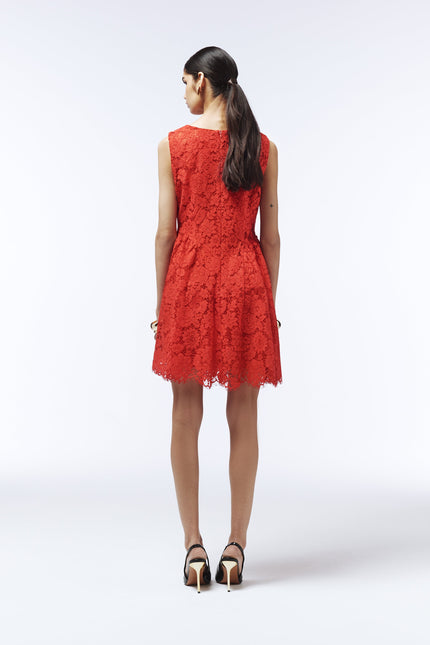 Elegant red lace mini dress styled with black heels and statement earrings