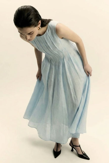 Woman wearing a light blue dress on a beige background