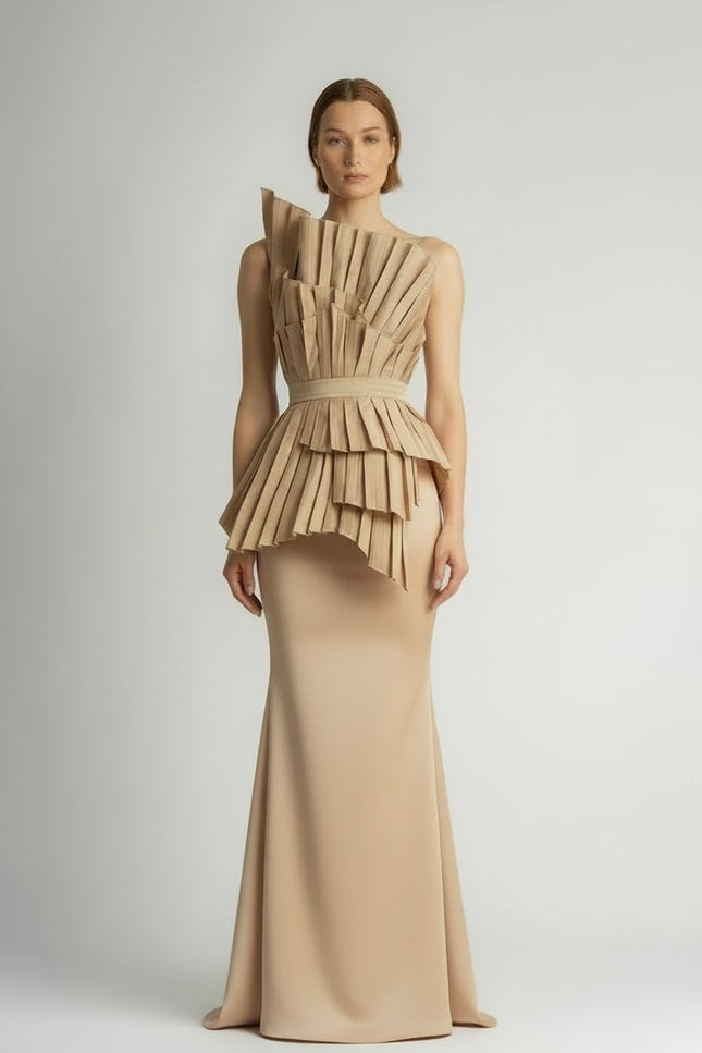 Model wearing a unique dress with a layered beige top and lace skirt on a plain background