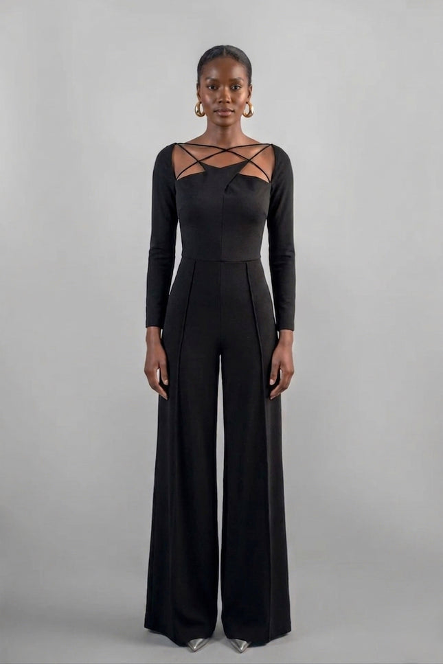 Woman wearing a black jumpsuit with long sleeves and lace-up details on a gray background