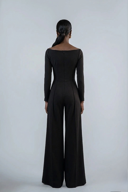 Person wearing a black jumpsuit on a white background