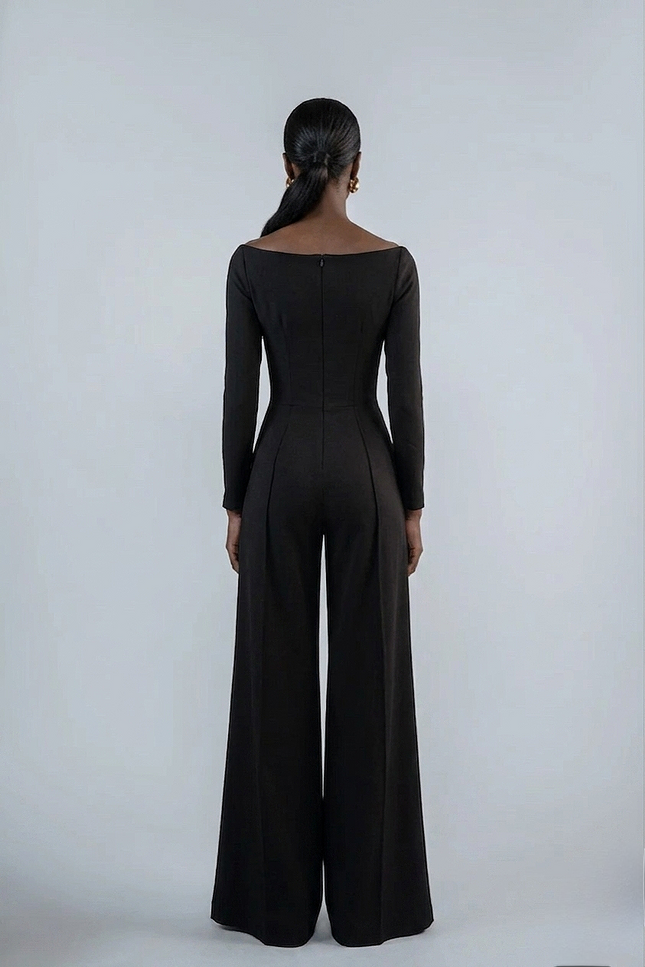 Person wearing a black jumpsuit on a white background