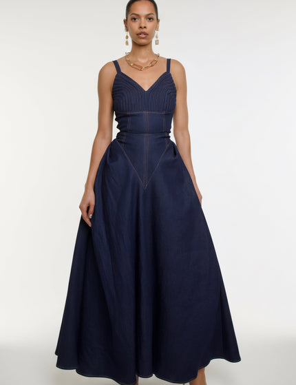 Woman wearing a navy blue dress with a white background