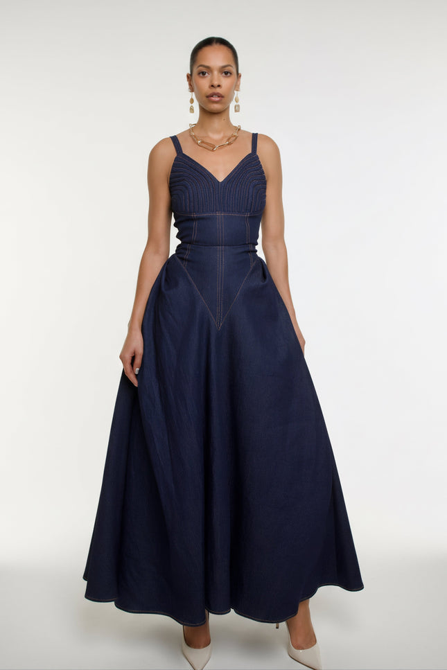 Woman wearing a navy blue dress with a white background
