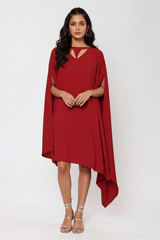 Woman wearing a red dress with a cape on a white background